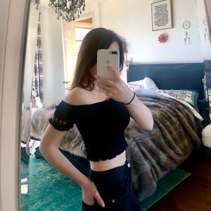 Cute crop top with floral stitching.